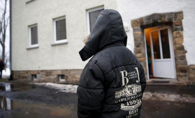 A migrant boy stands in front of an asylum shelter in Clausnitz, Germany, March 2, 2016. REUTERS/Hannibal Hanschke