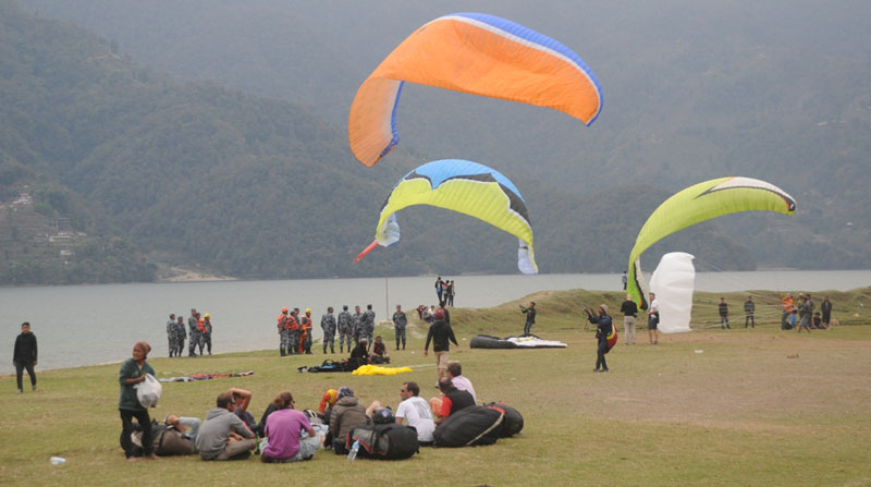 Paragliders who were rescued after being fallen into the Phewa Lake rest, in Pokhara of Kaski, on Tuesday, March 1, 2016. Photo: THT