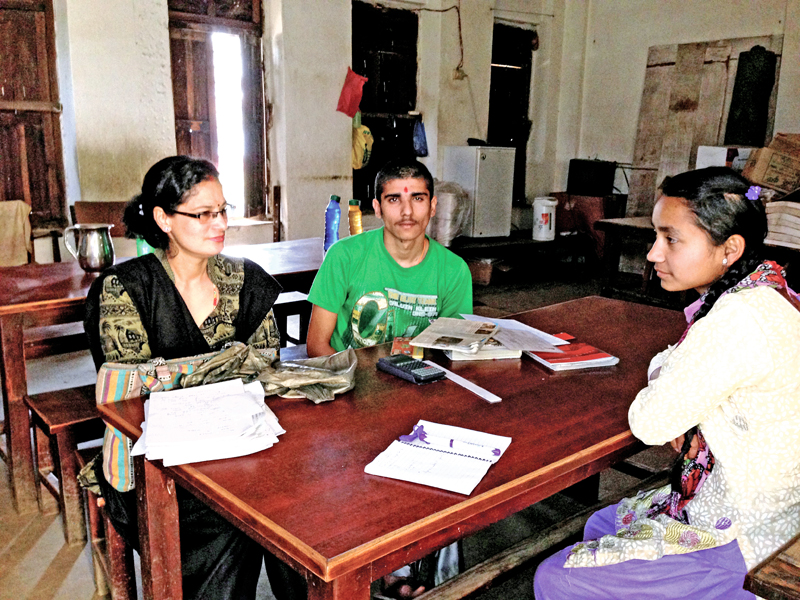 A visually impaired boy Sujan Dhakal preparing for his SLC exams with his teacher Indira Aryal and writer Sarita Sunar, on Tuesday, March 29, 2016. Photo: THT