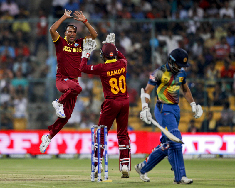 West Indiesu0092 Samuel Badree, left, celebrates after taking the wicket of Sri Lanka's Milinda Siriwardana, right, during their ICC World Twenty20 2016 cricket match in Bangalore, India, Sunday, March 20, 2016. Photo: AP