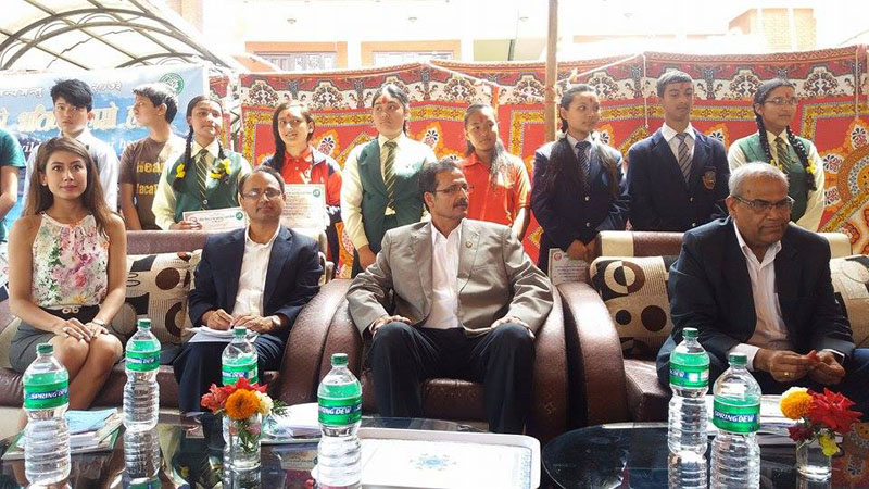 Minister for Forest and Soil Conservation, Agni Prasad Sapkota (centre), Miss Nepal Asmi Shrestha (left) and others including students with outstanding performances in poem and art competitions at the interaction programme organised in Kathmandu as the 21st Wildlife Week concludes, on Tuesday, April 19, 2016. Photo: RSS