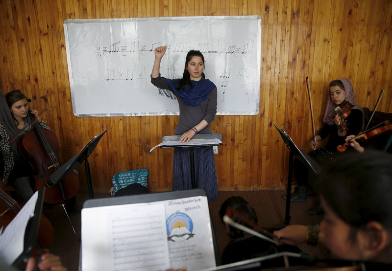 Negin Ekhpulwak, leader of the Zohra orchestra, an ensemble of 35 women, conducts during a rehearsal at Afghanistan's National Institute of Music, in Kabul, Afghanistan, on April 9, 2016. Photo: Ahmad Masood/Reuters
