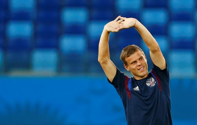 Russia's national soccer team player Alexander Kokorin stretches during a training session in the Pantanal arena in Cuiaba, June 16, 2014. REUTERS/Eddie Keogh