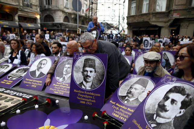Activists hold portraits of victims during a silent demonstration to commemorate the mass killings of Armenians by Ottoman Turks in Istanbul, Turkey April 24, 2016. REUTERS/Osman Orsal