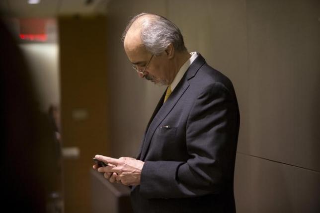 Syrian U.N. Ambassador Bashar Ja'afari checks his cellular device before a meeting with U.N. Secretary-General Ban Ki-moon during the United Nations General Assembly at the United Nations in Manhattan, New York October 1, 2015.  REUTERS/Andrew Kelly/Files