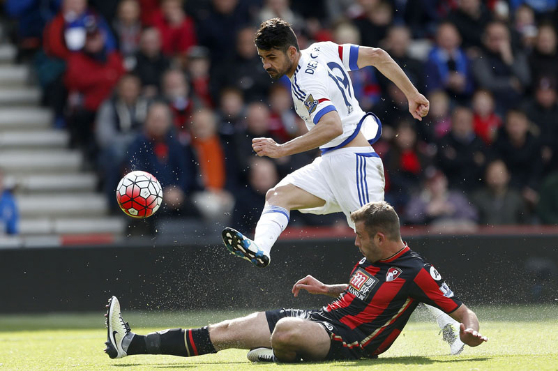 Chelsea's Diego Costa (left) and AFC Bournemouth's Steve Cook battle for the ball during the English Premier League football match between AFC Bournemouth and Chelsea FC at the Vitality Stadium in Bournemouth, England. on Saturday April 23, 2016. Photo: Steve Paston /PA via AP