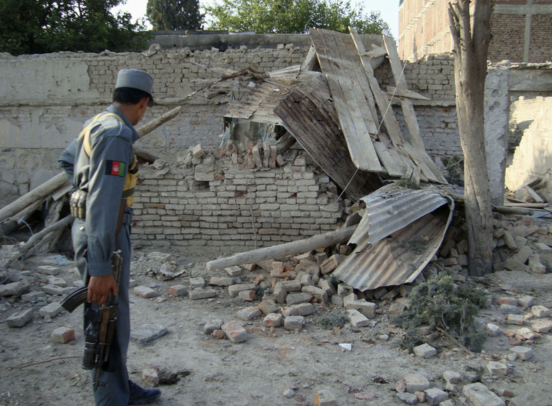 FILE -  An Afghan police officer looks at a guard post which was damaged in an attack in Khost, east of Kabul, Afghanistan, on July 25, 2009. Recently declassified US government cables suggest Pakistanu2019s intelligence service paid a US-designated terrorist organization $200,000 to carry out one of the deadliest attacks against the CIA in the spy agencyu2019s history. Photo: Nishanuddin Khan/AP