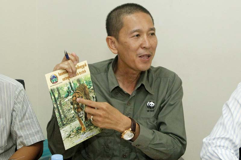 Chhith Sam Ath, Cambodia Director of the World Wildlife Fund (WWF), shows a booklet  during a press conference, in Phnom Penh, Cambodia, on Wednesday, April 6, 2016. Photo: AP