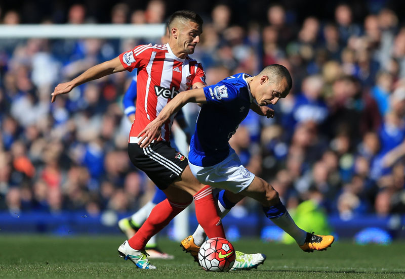 Everton's Leon Osman and Southampton's Dusan Tadic ( left) battle for the ball  during the English Premier League soccer match at Goodison Park, Liverpool, England, on Saturday April 16, 2016. Photo: Nigel French/PA via AP