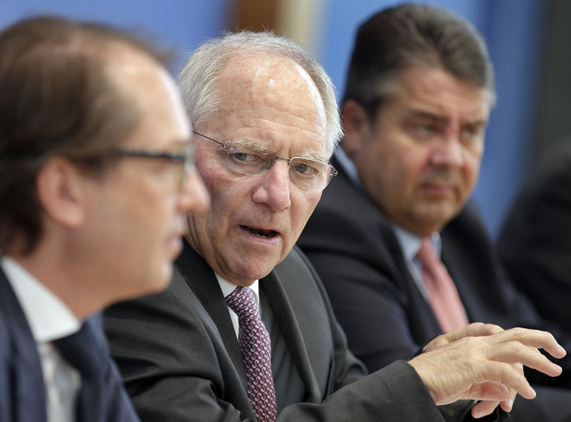From left, German Transportation Minister Alexander Dobrindt, German Finance Minister Wolfgang Schaeuble and German Minister for Economic Affairs and Energy, Sigmar Gabriel, address the media during a joint press conference in Berlin, Germany, on Wednesday, April 27, 2016. Photo: Michael Sohn/AP