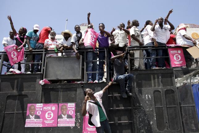 Supporters of PHTK political party react as they ride in the back of a truck during a demonstration to demand the organization of a postponed presidential runoff election in Port-au-Prince, Haiti, April 14, 2016. REUTERS/Andres Martinez Casares