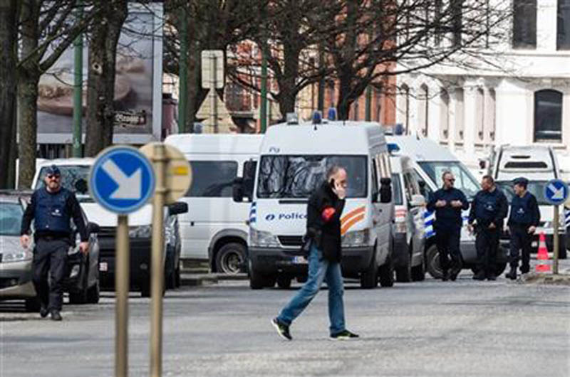Police secure an area during a house search in the Etterbeek neighborhood in Brussels on Saturday April 9, 2016. Photo: AP