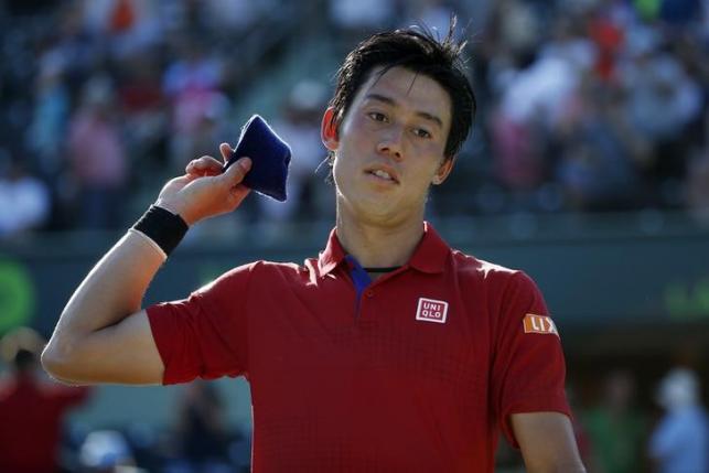 Mar 31, 2016; Key Biscayne, FL, USA; Kei Nishikori throws his wristband into the crowd after his match against Gael Monfils (not pictured) during a men's singles quarter final during day eleven of the Miami Open at Crandon Park Tennis Center. Nishikori won 4-6, 6-3, 7-6(3). Geoff Burke-USA TODAY Sports