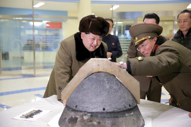 North Korean leader Kim Jong Un looks at a rocket warhead tip after a simulated test of atmospheric re-entry of a ballistic missile, at an unidentified location in this undated file photo released by North Korea's Korean Central News Agency (KCNA) in Pyongyang on March 15, 2016.     REUTERS/KCNA/Files