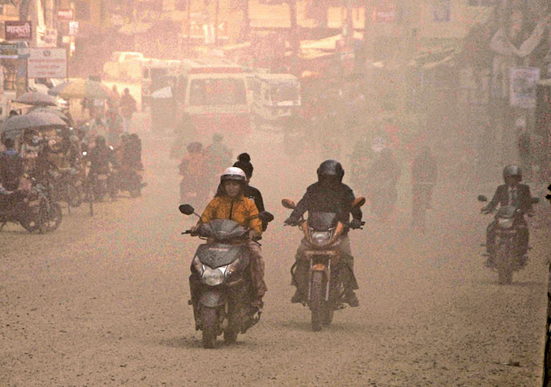 Vehicles raising a blinding cloud of dust as they pass a dusty road ar gwarko, Lalitpur, on Wednesday, March 30, 2016. Photo: THT