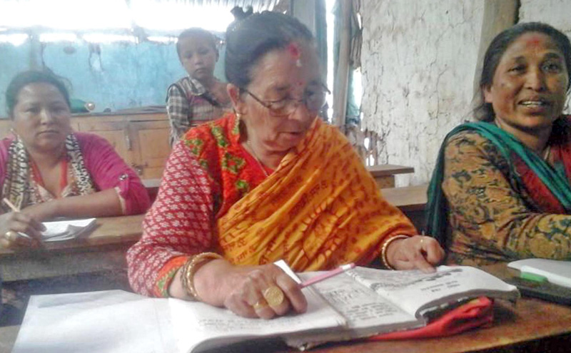 An octogenarian, Man Kumari Layalu, of Salleri Tole at Diktel-2, Khotang attends the adult literacy class, run with the financial support provided by the District Education Office, Khotang on Monday, April 18, 2016. Photo: RSS