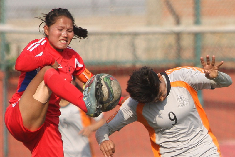 Nepal APF Club's Sabitra Bhandari (right) and Tribhuvan Army Club skipper Anjali Waiba vie for the ball during their Womenu0092s National Football League match at the ANFA Complex grounds in Lalitpur on Friday. Photo: Udipt Singh ChhetryTHT