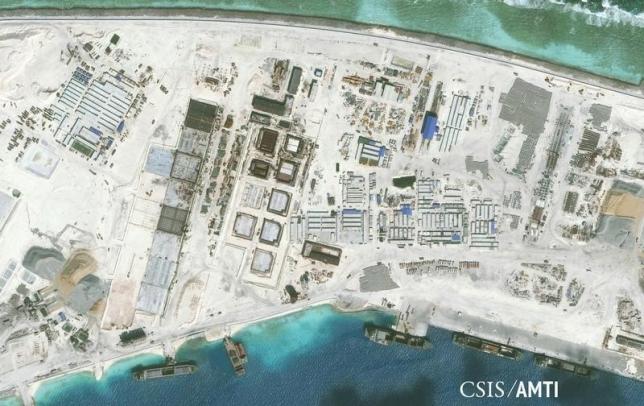 The northwest side of Mischief Reef showing a 1,900 foot seawall and newly-constructed infrastructure including housing, an artificial turf parade grounds, cement plants, and docking facilities are shown in this Center for Strategic and International Studies (CSIS) Asia Maritime Transparency Initiative January 8, 2016 satellite image released to Reuters on January 15, 2016. REUTERS/CSIS Asia Maritime Transparency Initiative/Digital Globe/Handout via Reuters