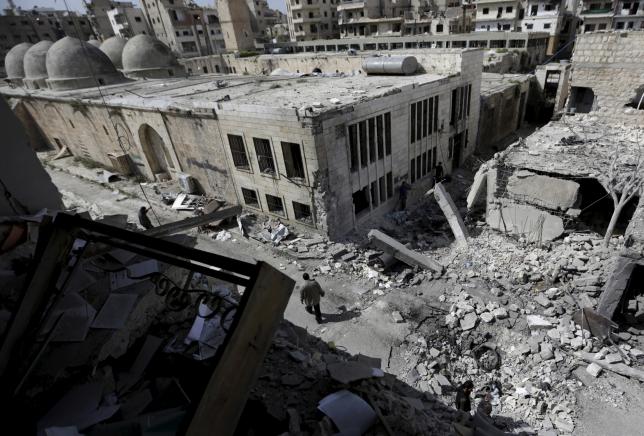 People inspect the damage after a car bomb exploded and targeted a religious center in the rebel-controlled area of Maaret al-Numan town in Idlib province, Syria April 5, 2016. REUTERS/Khalil Ashawi