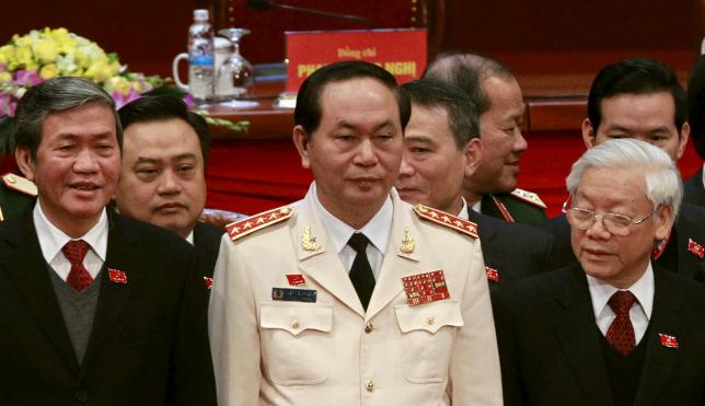 Vietnam's Public Security (Police) Minister General Tran Dai Quang (C) stands with Communist Party's General Secretary Nguyen Phu Trong (R) and Politburo member Dinh The Huynh (L) at a closing ceremony of 12th National Congress of the Party in Hanoi, January 28, 2016. REUTERS/Kham