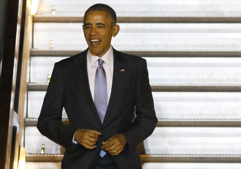 President of the United States Barack Obama smiles as he trots down the steps of Air Force One at Stansted Airport, England, on Thursday, April 21, 2016. Photo: Kirsty Wigglesworth/AP