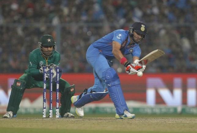 Cricket - India v Pakistan- World Twenty20 cricket tournament - Kolkata, India, 19/03/2016. India's Yuvraj Singh (R) plays a shot as Pakistan's wicketkeeper Sarfraz Ahmed looks on. REUTERS/Rupak De Chowdhuri/Files