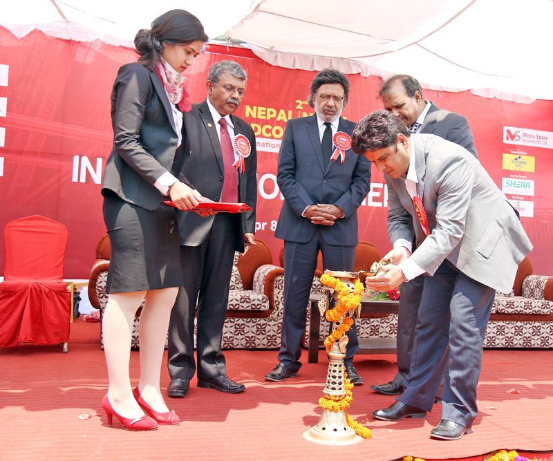 Minister of State for Finance, Damodar Bhandari, lights a panas during the inauguration of second Nepal Buildcon Expo at Bhrikutimandap on Friday, April 8, 2016. The expo which features constructions equipment from home and abroad will last till Monday.