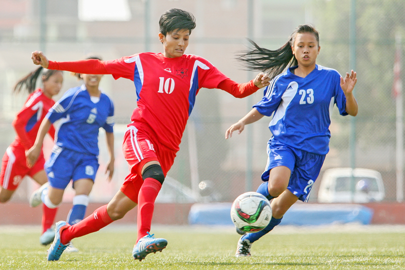 TACu0092s Krishna Khatri (left) vies for nthe ball with Eastern Regionu0092s Hina nkhatri during their Womenu0092s National nFootball League match at the ANFA Complex grounds in Lalitpur on Friday, April 29, 2016. Photo: THT