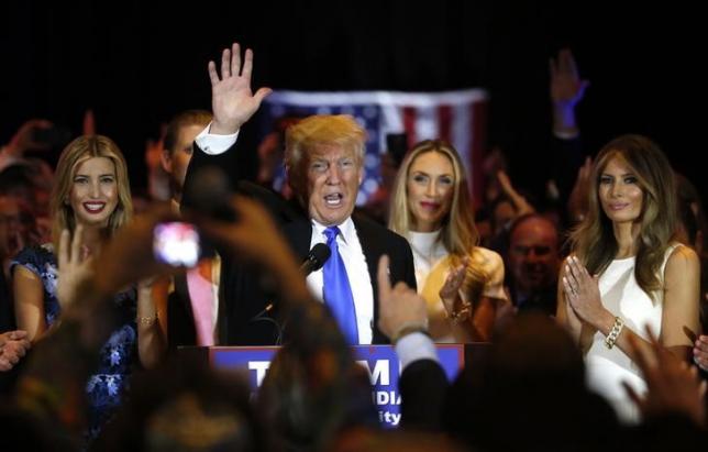 Republican U.S. presidential candidate Donald Trump waves with his daughter Ivanka (L), his son Eric's wife Lara Yunaska (2nd R) and his wife Melania (R) at his side after speaking at a campaign victory party after rival candidate Senator Ted Cruz dropped out of the race for the Republican presidential nomination following the results of the Indiana state primary, at Trump Tower in Manhattan, New York, U.S., May 3, 2016. REUTERS/Lucas Jackson