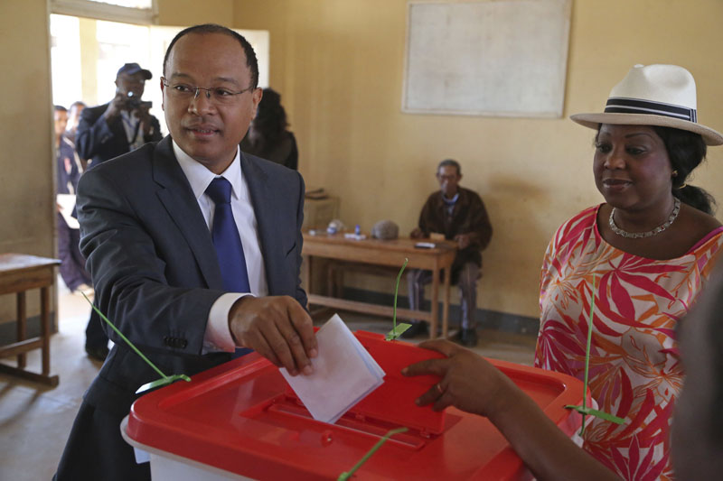FILE - United Nations official Fatma Samoura (right) observes as Madagascar presidential hopeful Edgard Razafindravahy casts his ballot, in Antananarivo, Madagascar, on October 25, 2013. Photo: Schalk van Zuydam/AP