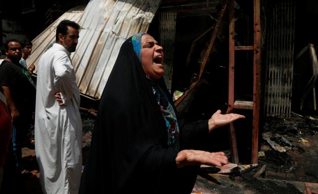 A woman reacts at the scene of a car bomb attack in Baghdad's mainly Shi'ite district of Sadr City, Iraq, May 11, 2016. REUTERS/Wissm al-Okili