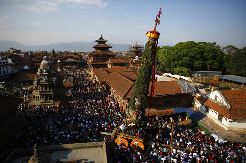Revellers pull the chariot of Rato Machhindranath, the God of Rain, in Patan Durbar Square, a UNESCO World Heritage Site, in Lalitpur, on Thursday, May 12, 2016. Photo: Skanda Gautam