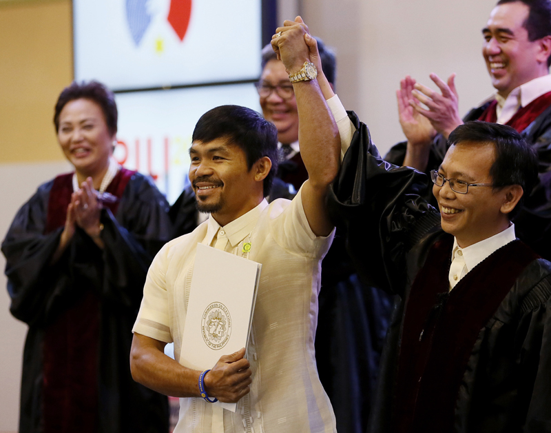 Filipino boxing great Manny Pacquiao holds his Certificate of Canvass as he is proclaimed the Seventh Senator by Commissioner Christopher Lim, right, in ceremony at the Commission on Elections Thursday, May 19, 2016 in suburban Pasay city south of Manila, Philippines. Photo: AP