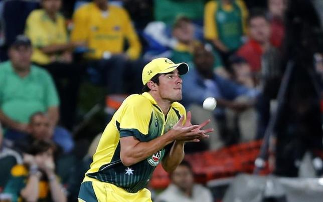 Australia's Moises Henriques makes a catch to dismiss South Africa's JP Duminy during the final of the T20 cricket test match in Centurion, March 14, 2014.  REUTERS/Siphiwe Sibeko/Files
