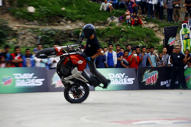 A stuntman performs a wheelie during an event, Day of Dares, in Kirtipur on Wednesday, May 25, 2016. Photo: Skanda Gautam
