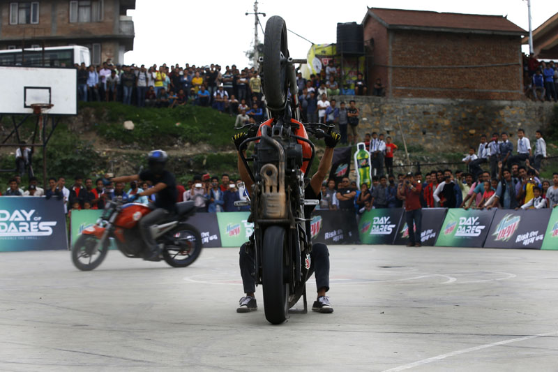 A stuntman performs a wheelie during an event, Day of Dares, in Kirtipur on Wednesday, May 25, 2016. Photo: Skanda Gautam