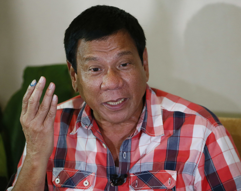 FILE- In this May 9, 2016, file photo, then front-running presidential candidate Mayor Rodrigo Duterte gestures during his second news conference after voting in a polling precinct at Daniel R. Aguinaldo National High School, Matina district, his hometown in Davao city in southern Philippines Monday, May 9, 2016. Photo: AP