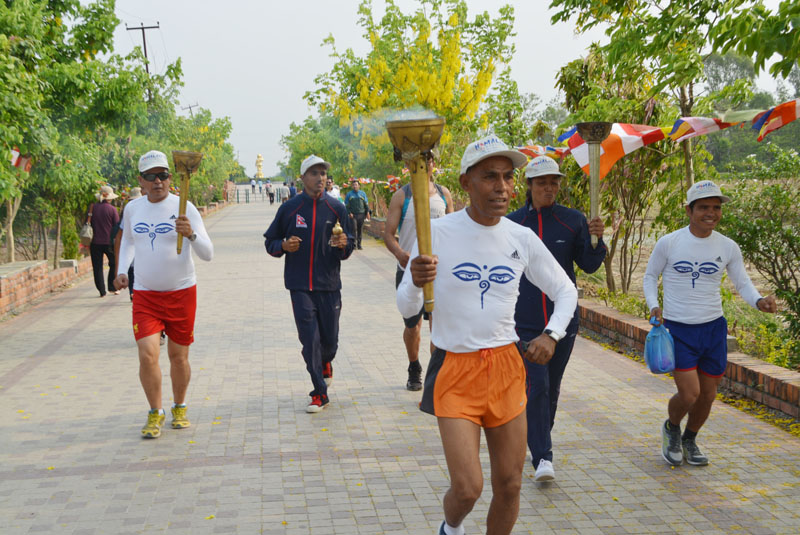 Olympian Baikuntha Manandhar marches on as he holds the Lumbini Peace March and Peace Flame, which is scheduled to reach the Mt Everest Base Camp on May 27, in Lumbini on Sunday.  Photo: THT