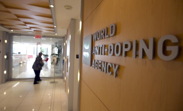 A woman walks into the head office for the World Anti-Doping Agency (WADA) in Montreal, Quebec, Canada on November 9, 2015.  REUTERS/Christinne Muschi/File Photo