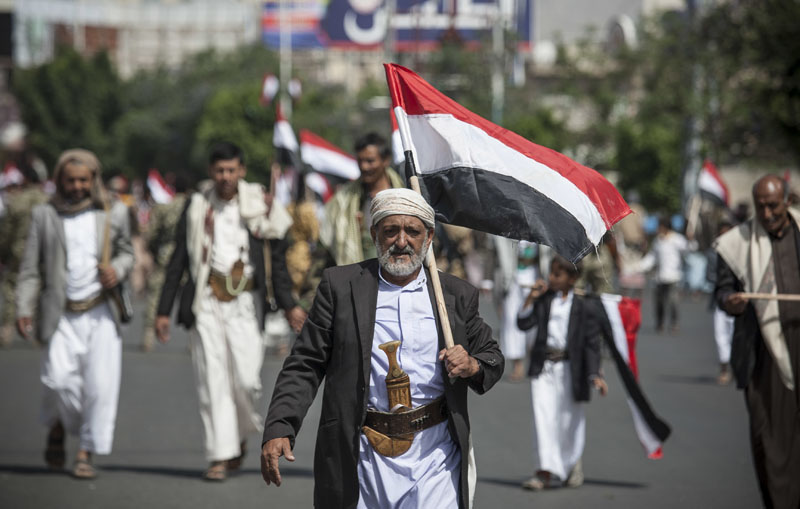 A man holds Yemen's flag during a ceremony to commemorate the 26th anniversary of Yemen's reunification, in Sanaa, Yemen, on Sunday, May 22, 2016. South and North Yemen were independent states until unification in 1990. Photo: Hani Mohammed/AP