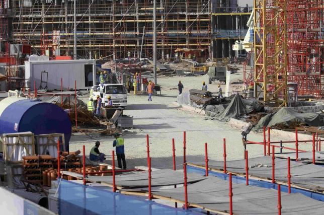 FILE- Migrant labourers work at a construction site at the Aspire Zone in Doha, Qatar, March 26, 2016. REUTERS/Naseem Zeitoon
