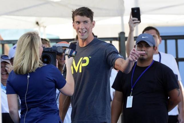 Aug 8, 2015; San Antonio, TX, USA; Michael Phelps speaks to the media after winning the men's 100-meter butterfly final during the Phillips 66 National Championships at Northside Swim Center. Mandatory Credit: Soobum Im-USA TODAY Sports