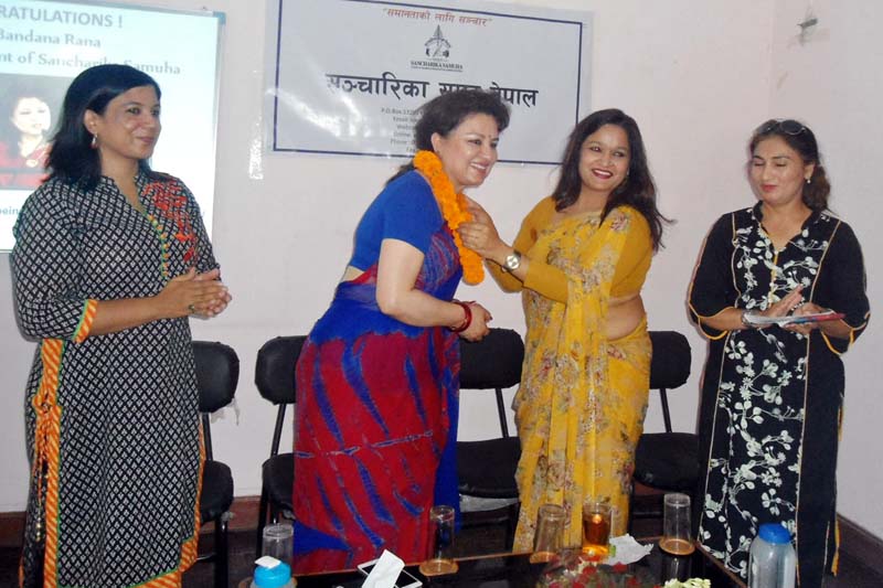 Newly elected to the UN CEDAW committee, human rights activist Bandana Rana being honoured by the Sancharika Samuha Chair Nirmala Sharma, on Tuesday, June 28, 2016. Photo: RSS
