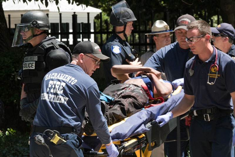 Paramedics rush a stabbing victim away on a gurney on Sunday, June 26, 2016, after members of right-wing extremists groups holding a rally outside the California state Capitol building in Sacramento clashed with counter-protesters, authorities said. Sacramento Police spokesman Matt McPhail said the Traditionalist Workers Party had scheduled and received a permit to protest at noon Sunday in front of the Capitol. Photo: AP