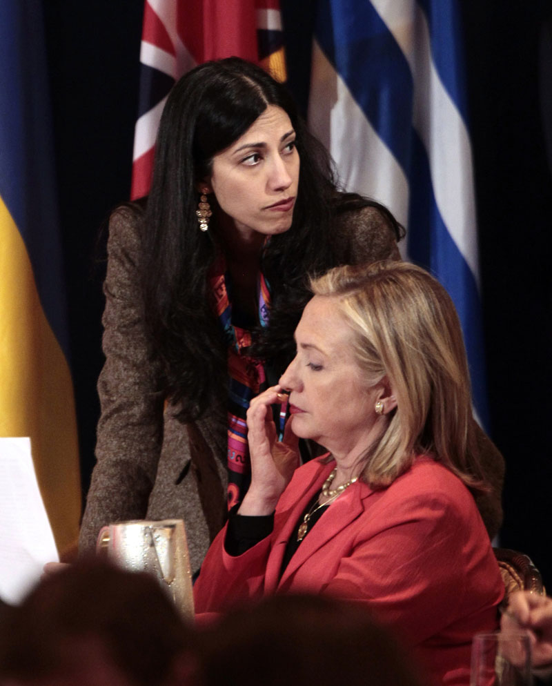 Huma Abedin, (top) deputy chief of staff and aide to Secretary of State Hillary Rodham Clinton (right) during a meeting with leaders for the Open Government Partnership in New York, on September 20, 2011. Photo: AP