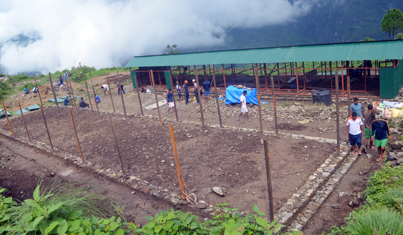 A community shelter is being constructed for earthquake survivors of Jharlang-3 of northern Dhading by Nepal Army personnel, on Friday, June 24, 2014. Photo: RSS