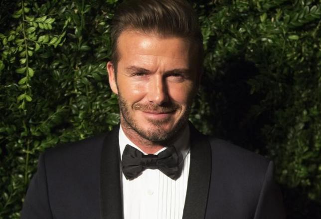 Former British soccer player David Beckham smiles at the Evening Standard Theatre awards in London November 30, 2014. REUTERS/Neil Hall/Files