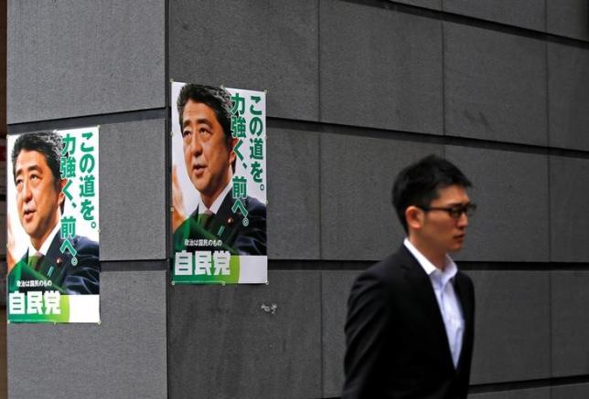 A man walks past posters for the July 10 upper house election with the image of Shinzo Abe, Japan's Prime Minister and leader of Japan's ruling Liberal Democratic Party (LDP), in Tokyo, Japan June 22, 2016. REUTERS/Toru Hanai