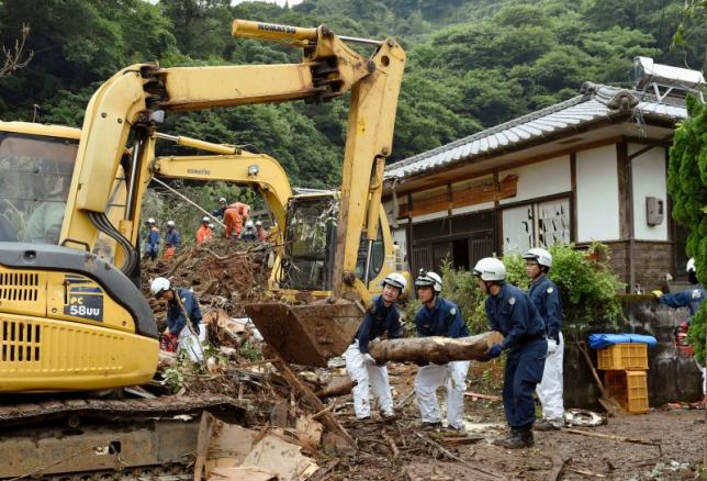Rescue team members conduct search and rescue operation at a landslide site caused by heavy rain in Uto, Kumamoto prefecture, Japan, in this photo taken by Kyodo June 21, 2016. Kyodo/via REUTERS