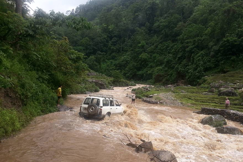 A jeep travels along the Mewa stream, swollen after torrential rain, near Phidim, the district headquarters of Panchthar, on Tuesday, June 21, 2016. Photo: RSS